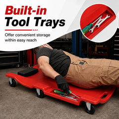 The garage creeper showing the side storage trays holding tools for easy access