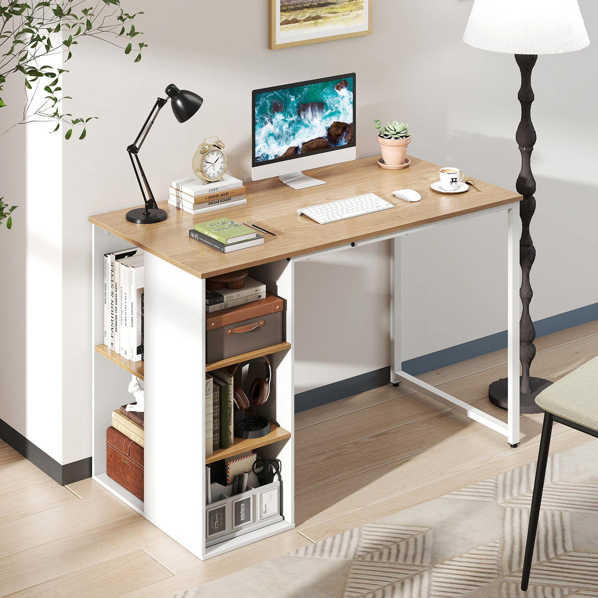 The computer desk in a home office setting with a computer, lamp and books