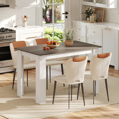 The dining table set for four people in a modern kitchen setting