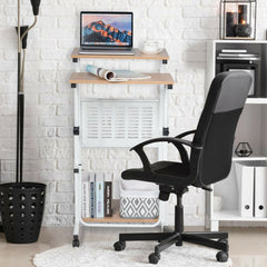 The mobile desk positioned next to a white bookshelf with a black office chair in front