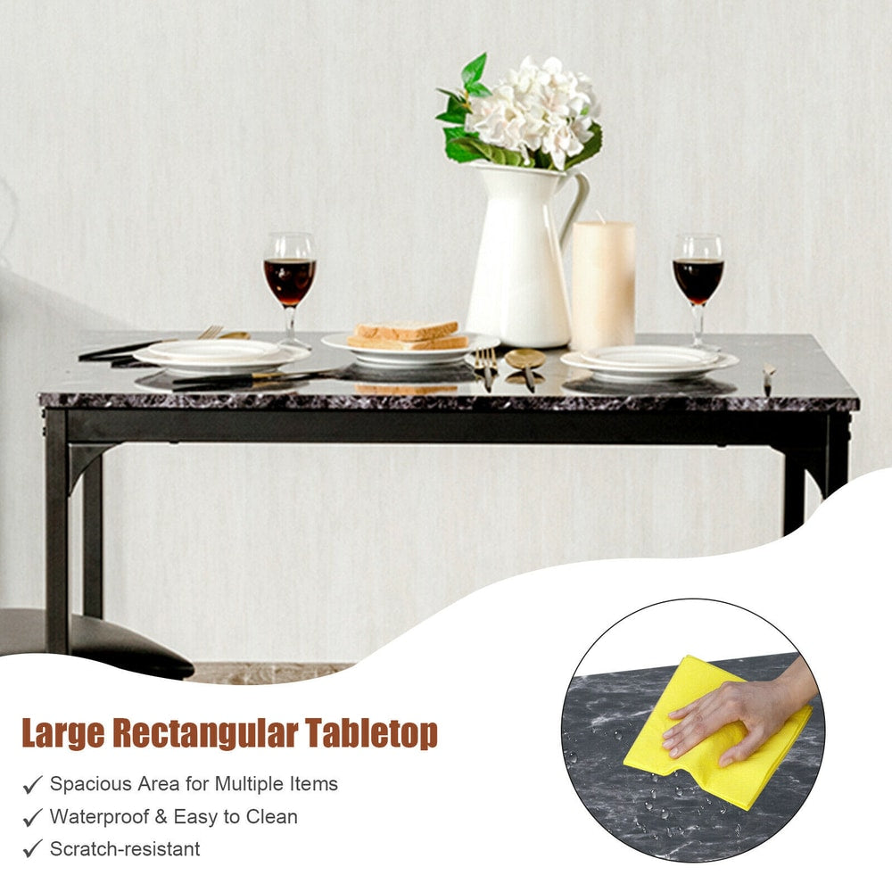 The dining table surface being wiped clean with a yellow cloth to show the easy maintenance