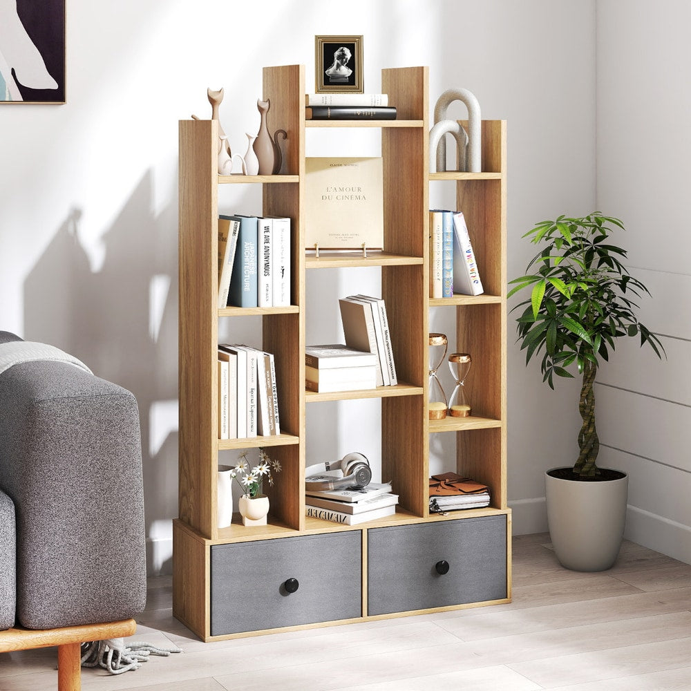 The wooden bookcase with drawers is shown in a living room setting next to a sofa