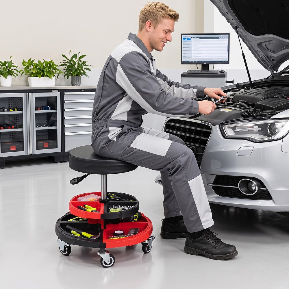 Mechanic using the rolling stool to work on a car engine