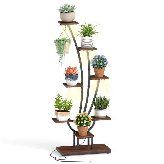 The plant stand featuring multiple tiers and built-in lighting with a variety of greenery