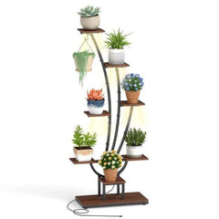 The plant stand featuring multiple tiers and built-in lighting with a variety of greenery