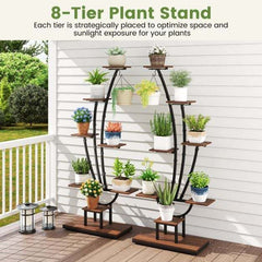 The plant stand displayed on a wooden outdoor deck filled with assorted potted plants