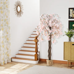 Artificial cherry blossom tree in a woven basket near a staircase