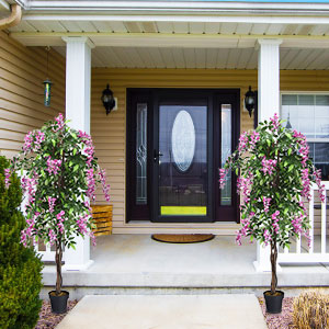 180CM Ficus Artificial Tree, two faux plants with pink flowers flanking a doorway on a porch