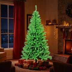 The green Christmas tree is set up in a living room with a fireplace and red curtains