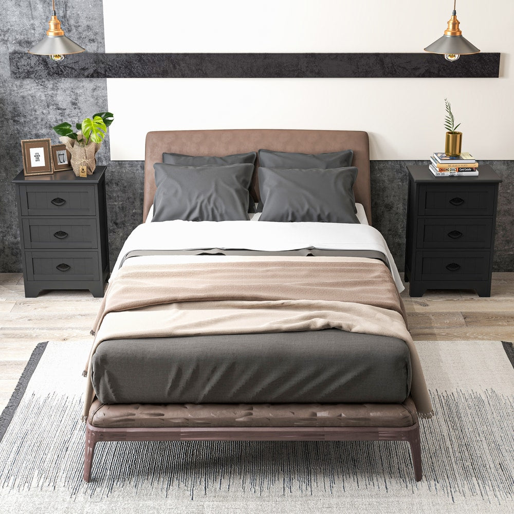 Two black vintage nightstands with three drawers, one on each side of a bed