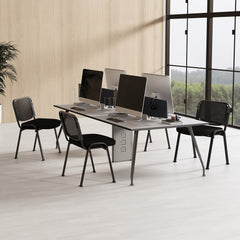 Black reception chairs at desks with computers