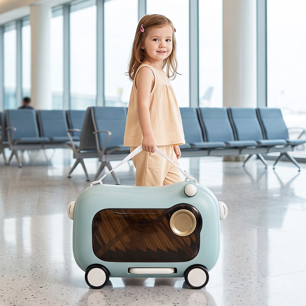 The kids luggage being pulled along by a young girl using a strap