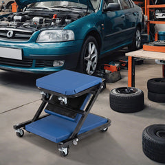 Blue rolling creeper seat next to a car in a garage workshop