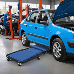 Blue rolling creeper seat positioned under a blue car in a garage