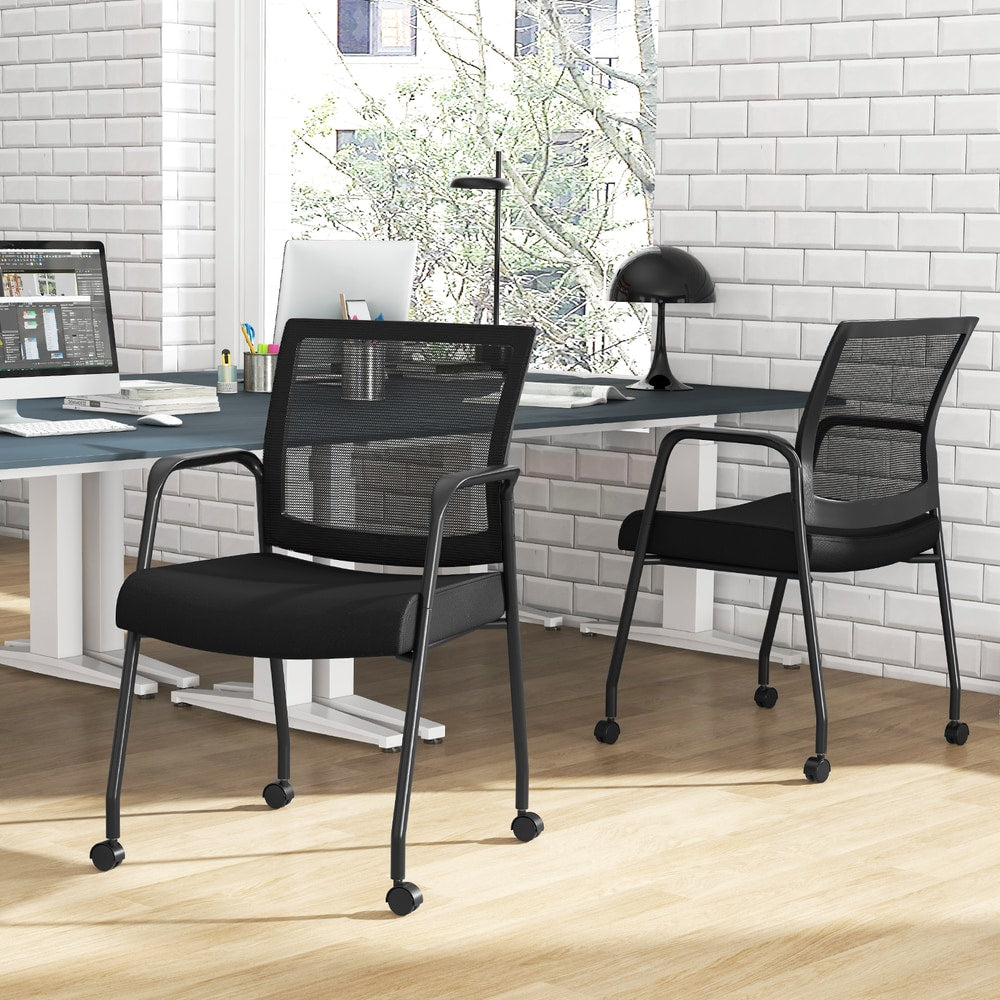The office chairs placed in a modern home office setting with a desk and brick wall
