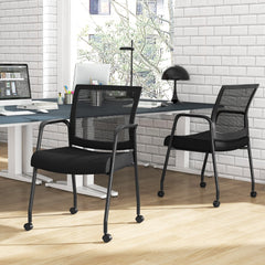 The office chairs placed in a modern home office setting with a desk and brick wall