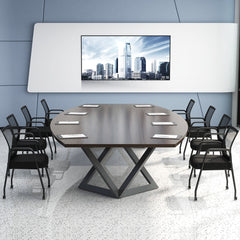 The office chairs set up around a large oval boardroom table with a wall screen