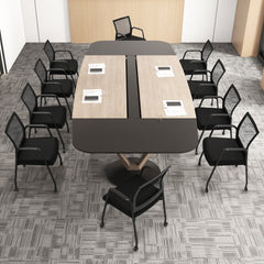 The office chairs placed around a large rectangular desk in a spacious office area
