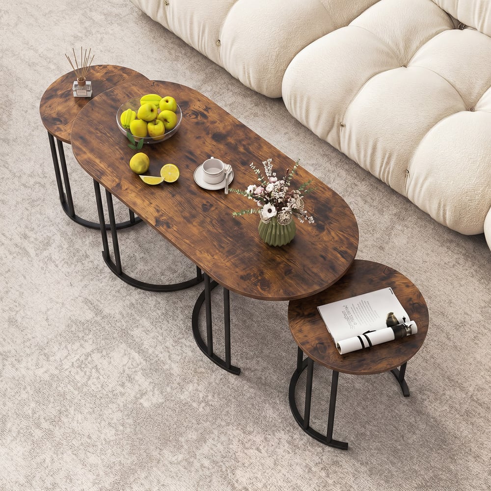 Rustic brown oval coffee tables arranged on a rug next to a sofa
