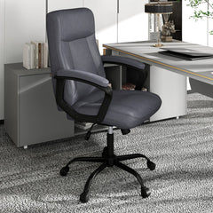 The office chair positioned in a modern home study next to a desk with books and a lamp