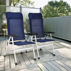 The outdoor chaise lounges positioned on a wooden patio deck with a glass balcony screen behind