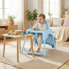 Happy baby sitting at a table in the blue convertible high chair