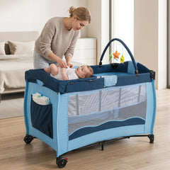 The baby playpen with a mother changing a baby on the attached changing table in a bedroom