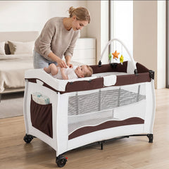 A mother places her baby on the changing table of the baby playpen