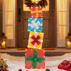 The glowing gift boxes standing upright in the snow at night