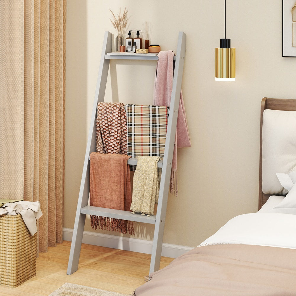 The grey blanket ladder holding scarves in a bedroom setting