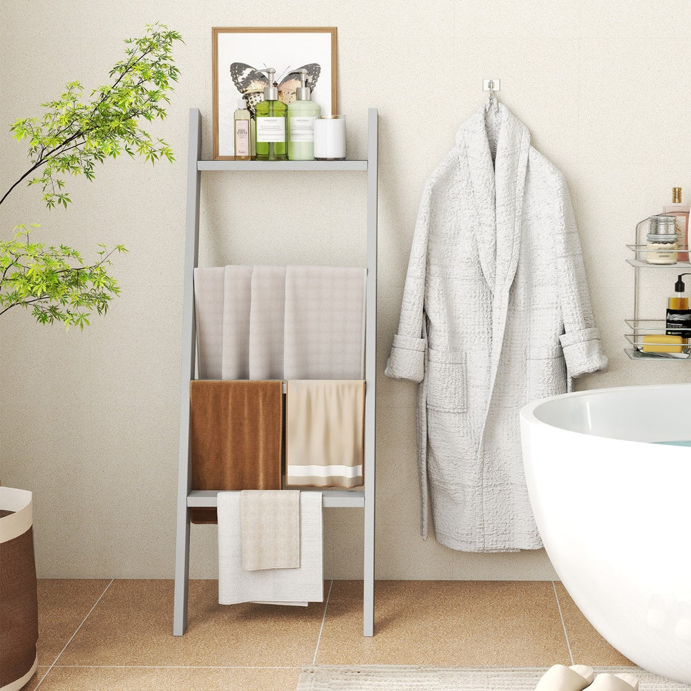 The grey blanket ladder used as a towel rack next to a bathtub