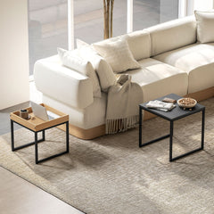 The two nesting coffee tables are shown in a living room setting next to a sofa