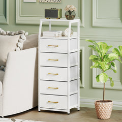 The storage cabinet placed in a living room next to a sofa and a potted plant