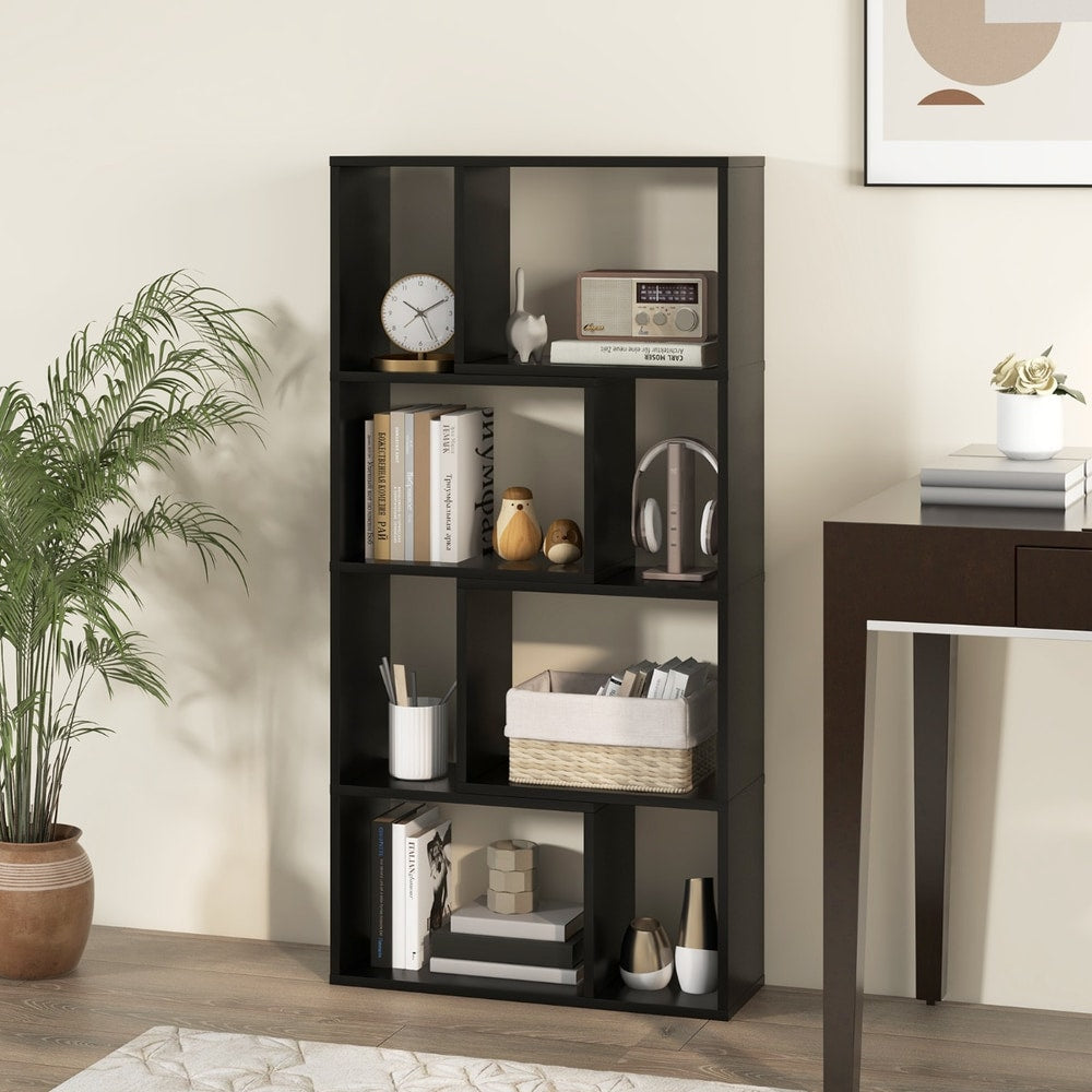The black open display unit decorated with ornaments and books beside a wooden desk