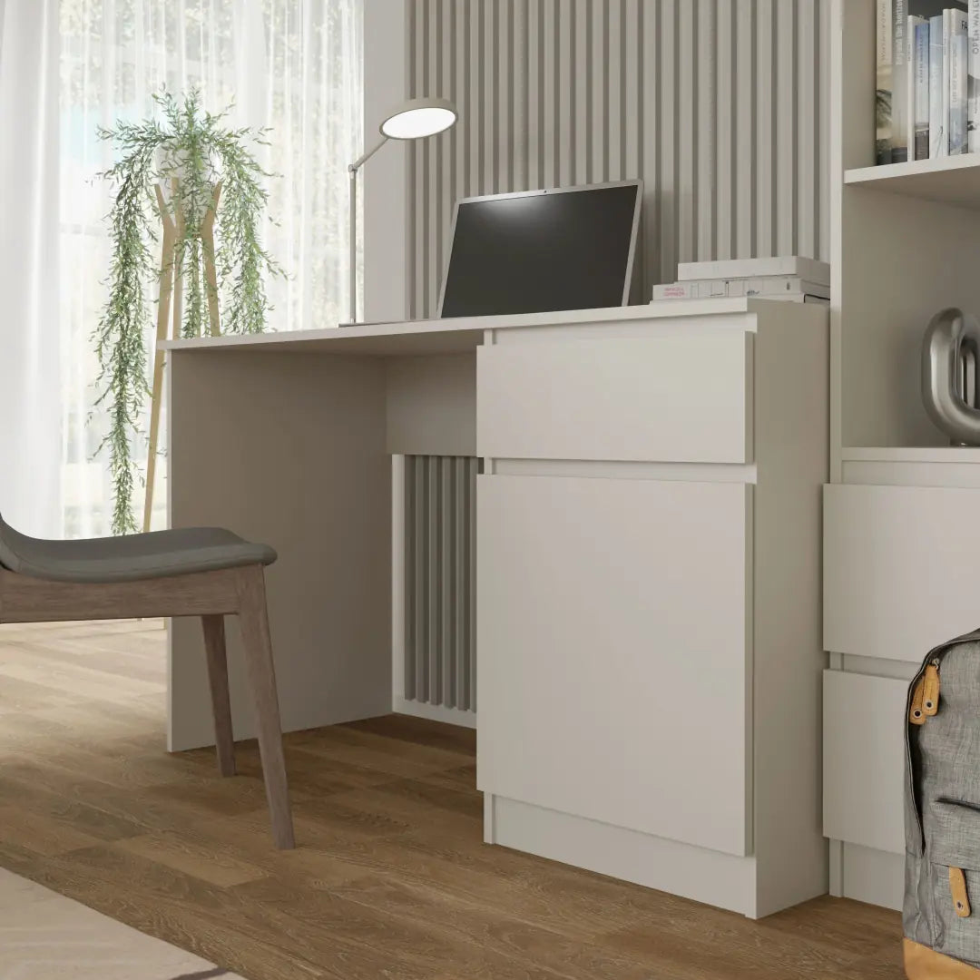 The white desk with a drawer and cupboard unit positioned in a room