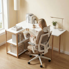 A woman reading a book at the L-shaped computer desk with storage shelves