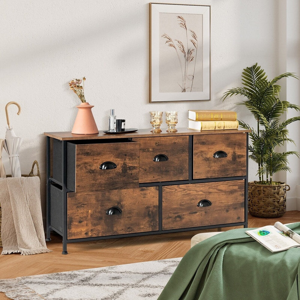The dresser placed in a living room with one drawer pulled open to show the interior space