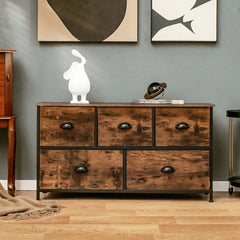 The chest of drawers positioned against a grey wall with decorative items on the wooden surface