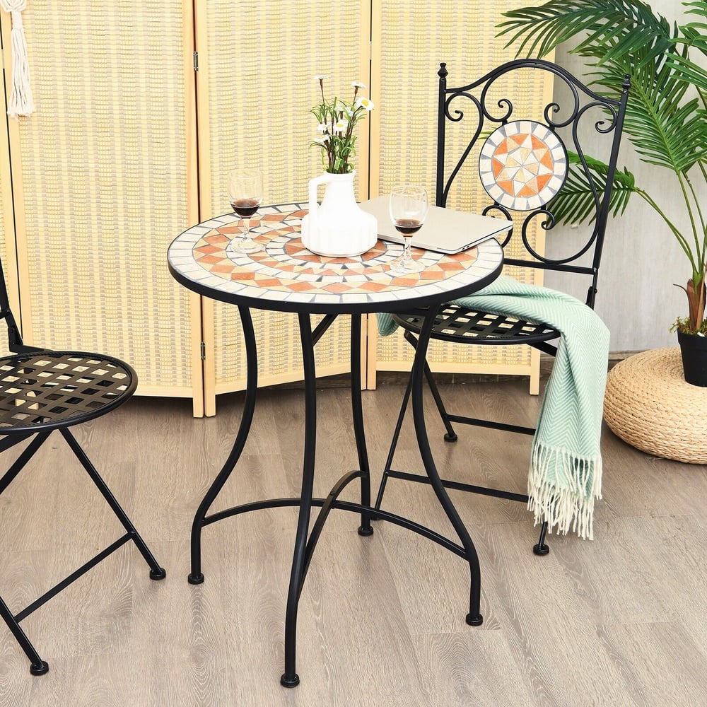 Mosaic round coffee table set up with two chairs in a garden setting