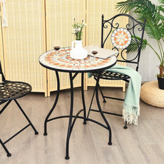Mosaic round coffee table set up with two chairs in a garden setting
