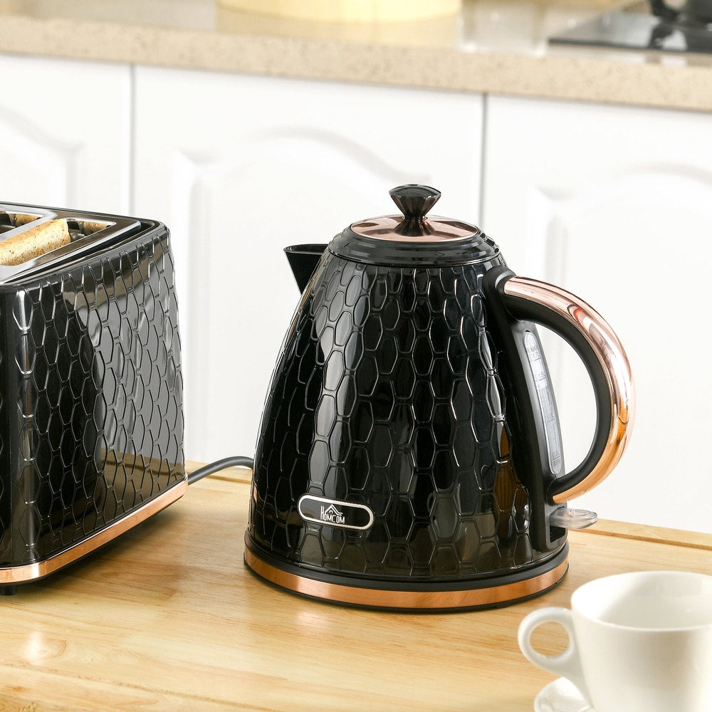 The black honeycomb kettle sits on a kitchen counter next to a toaster