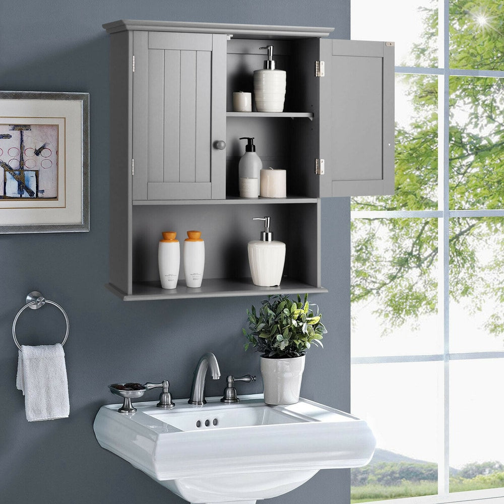 Grey wall cabinet with adjustable shelf in a bathroom, holding toiletries and a plant