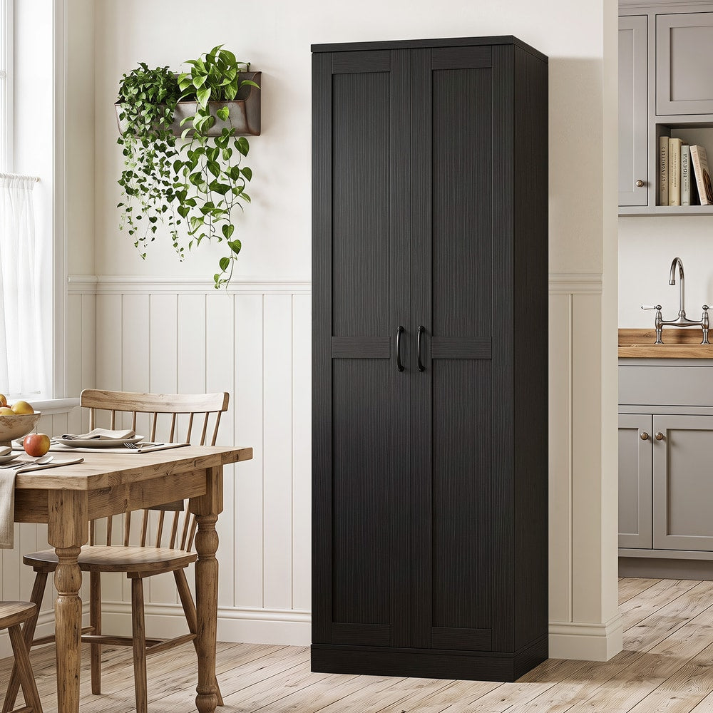 The tall storage unit standing closed in a dining room next to a wooden table and chairs