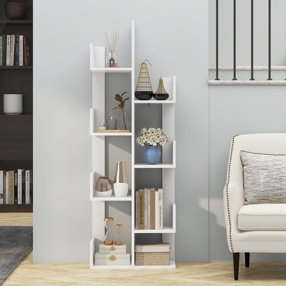 The white floor standing tree bookcase filled with various home decor items and books