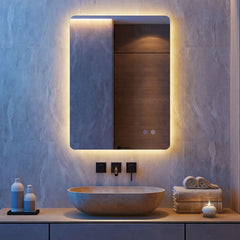 The illuminated mirror is mounted above a stone basin in a stylish bathroom with wooden cabinetry