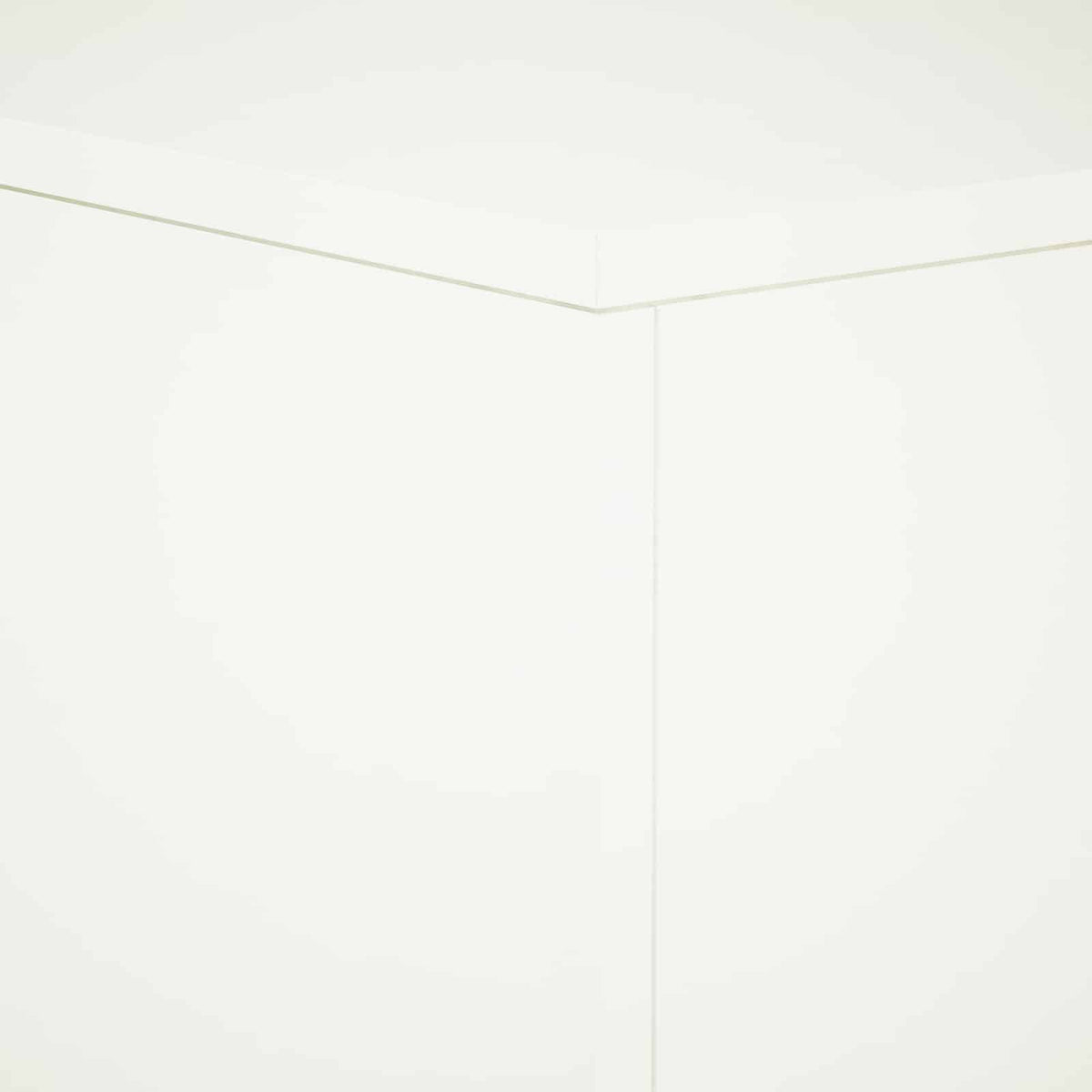A corner detail of the white plant stand, showing the seamless joinery of the panels
