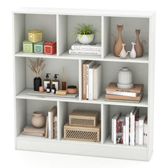 The white cube storage unit displaying decorative items and books