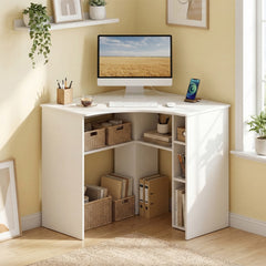 White corner computer desk with open storage shelves, set up in a bright room with a computer and plants