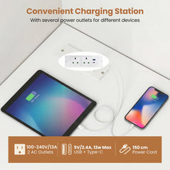 Close-up of the convenient charging station on the white computer desk, showing power outlets and USB ports