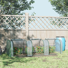 The tunnel greenhouse in use in a garden, with tomato plants growing inside